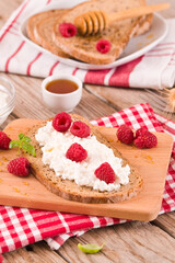 Rye bread with cottage cheese and raspberries.