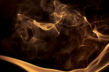 Gold smoke on black background.