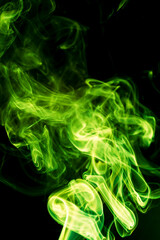 Green smoke on black background.