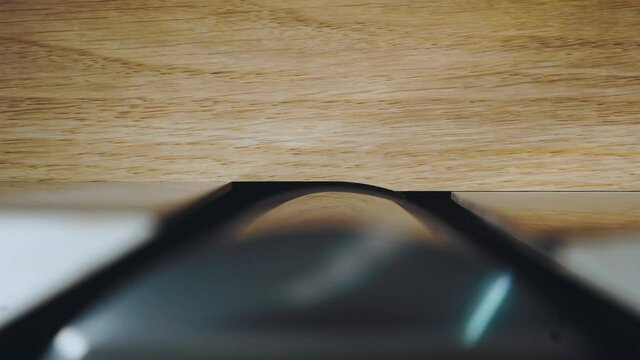 Close-up of working with wood on a machine in a carpentry workshop