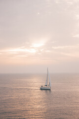 Fototapeta na wymiar Beautiful landscape overlooking the sea at sunset where a sailing boat sailing in Croatia.