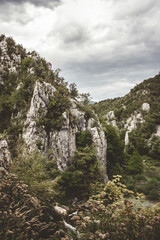 Beautiful landscape overlooking the cliffs surrounded by green trees on a cloudy day in Croatia