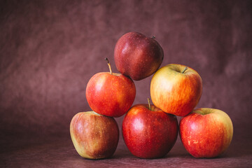 pyramid of red and yellow apples on wine watercolor background