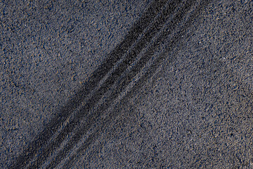 Aerial top view abstract texture and background of car tire drift skid mark on road race track,...