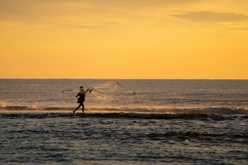 fisherman throwing his net
