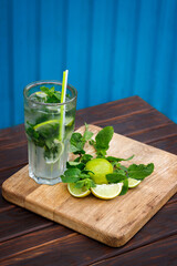 Сool summer drink mojito in a clear glass with lime and mint