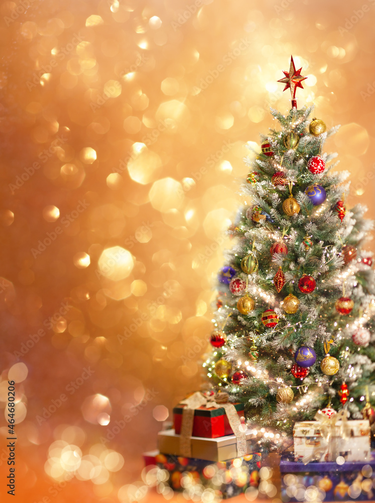 Poster Christmas tree with ornaments and festive gift boxes on golden background with festive bokeh.  New Year or Christmas greeting card