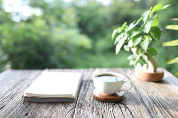 White coffee cup and plant pot and notepad