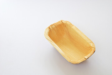 Organic rectancular bowl made from leaves of the areca nut palm isolated on white background....
