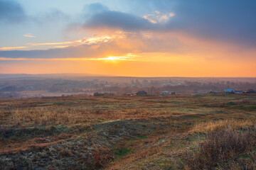 beautiful sunrise nature landscape. rural meadow at sunset with sun and mist - panorama nature sunrise with dramatic clouds sky. Calm of country meadow sunrise landscape background