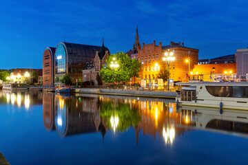 Panorama of Old town with reflection in Brda River at night, Bydgoszcz, Poland