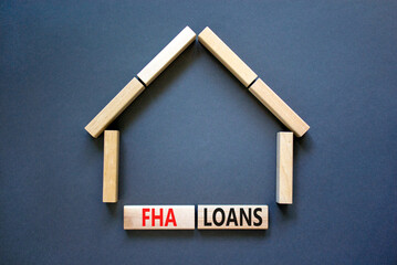 FHA federal housing administration loans symbol. Concept words 'FHA federal housing administration loans' on wooden blocks on a beautiful grey background. Business and FHA loans concept. Copy space.