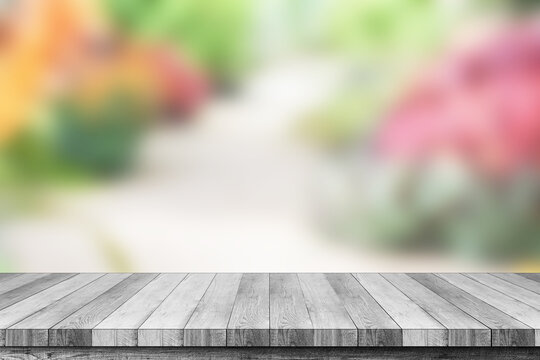 Grey wood table on blur garden background