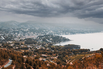 a city in autumn with gray clouds in the sky