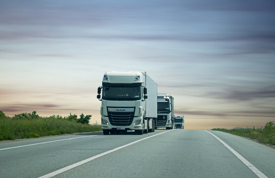 Freight trucks on the highway. The trucks move in line. DAF trucks. Romania, Severin. May, 23, 2021