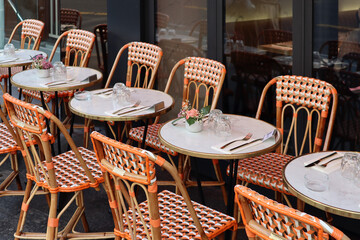 Terrace of a typical old Parisian restaurant with wicker chairs