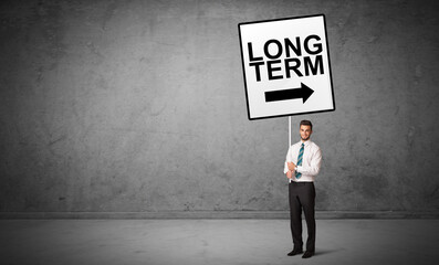 business person holding a traffic sign