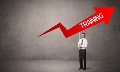 Young business person in casual holding road sign