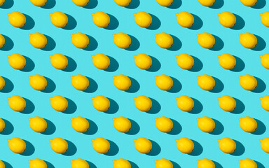 Trendy sunlight summer pattern made with yellow lemon slice on bright light blue background. Minimal summer concept. Flat lay. - 464689823