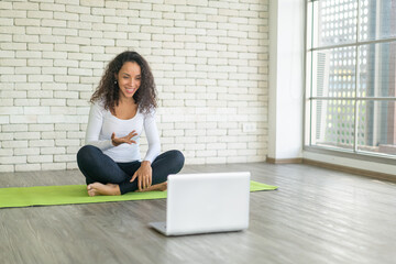 Latin woman teaching yoga online