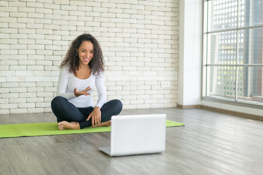 Latin woman teaching yoga online