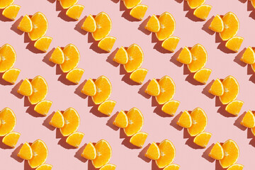 Fruit pattern of fresh ripe slice orange on pink background. Top view, copy space for your text. Fruit composition, healthy concept.