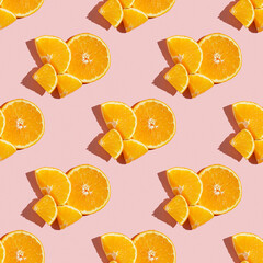 Fruit pattern of fresh ripe slice orange on pink background. Top view, copy space for your text. Fruit composition, healthy concept.