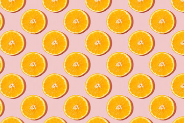 Fruit pattern of fresh ripe slice orange on pink background. Top view, copy space for your text. Fruit composition, healthy concept.