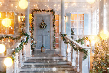 Christmas porch decoration idea. House entrance decorated for holidays. Golden and green wreath...