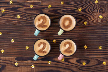 Numbers 2022 in four cups of latte as a sign of New Year in rural style.