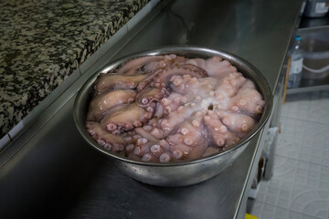 Detail of octopus in a pot inside a kitchen to be cooked.