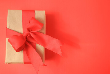 Gift  box  with a red ribbon and a red  background 