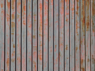 Grunge gray and red rusty metallic background. Textured structure made with metal rusty slats. Striped pattern