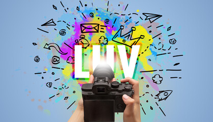 Close-up of a hand holding digital camera with abstract drawing