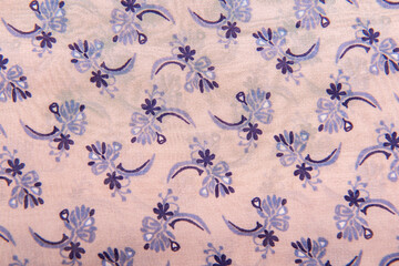 Close-up of abstract fabric texture with floral pattern pastel color background.