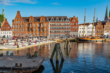 Tourists and Lübeck locals enjoy hot summer days in the square of the swing bridge over the River...