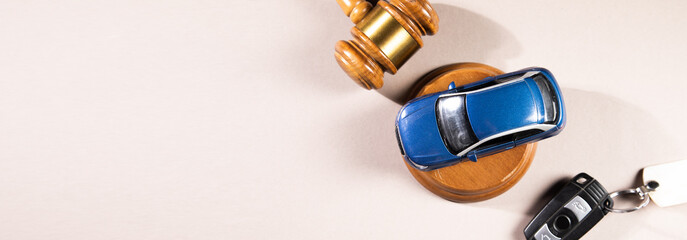 Judge gavel and car with keys
