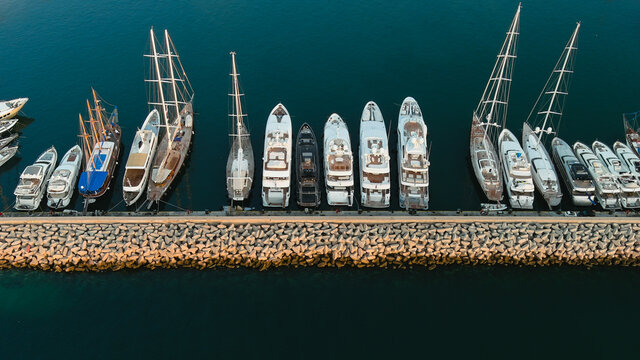 Speed And Sail Boats In The Marina, Concrete Breakwater For Storm Protection, Aerial View, Drone Shot.