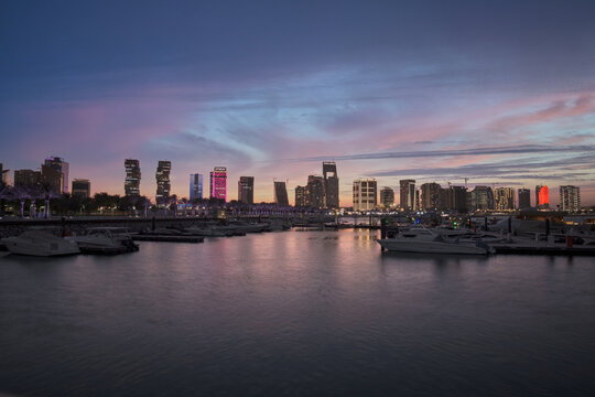 Lusail marina in Lusail city, Qatar at sunset with Yachts and boats ,Lusail skyline and clouds in the sky in in background © Mohamed