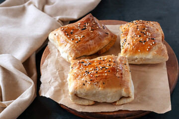 Samsa are Uzbek pies made of puff or plain dough stuffed with meat and onions. Real Uzbek samsa comes from oriental cuisine. Made from lamb and beef. Selective focus. 
