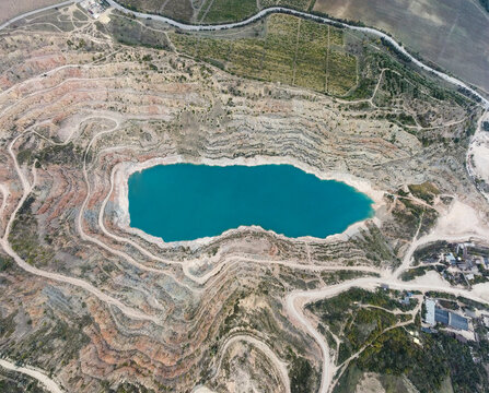 Top Aerial View Of Water Filled Quarry After Open Pit Mining