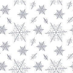 Seamless winter pattern of blue snowflakes on a white background for packaging and decoration