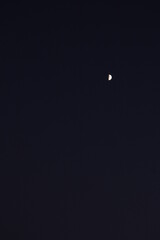 the moon that looks far away in the dark night