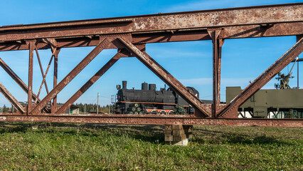 Retro Soviet steam locomotive. Veteran railways. Vintage black steam locomotive train rush railway.