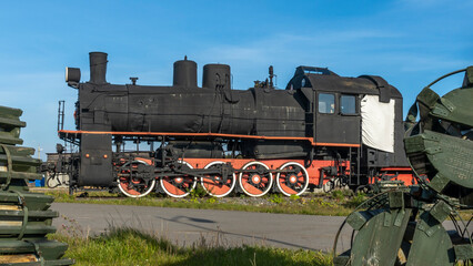 Retro Soviet steam locomotive. Veteran railways. Vintage black steam locomotive train rush railway.