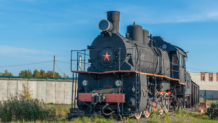 Retro Soviet steam locomotive. Veteran railways. Vintage black steam locomotive train rush railway.