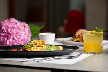 Savory Homemade Mushroom and Spinach green Crepes with Cheese and cup of tea isolated on gray background. Homemade food. Tasty breakfast. Selective focus.