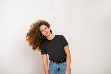  Attractive young female with brown curly hairstyle over white background
