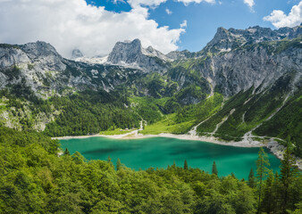 Fototapeta na wymiar Gosau lake and Dachstein summit mountain range and visible glacier ice during summertime, Upper-Austria, Europe