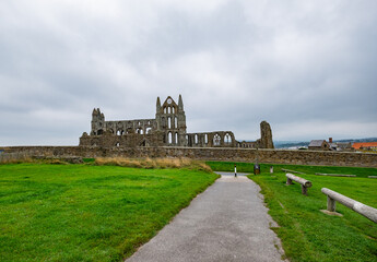 Fototapeta na wymiar Ancient abbey ruins on the clifftop of a seaside town in the Northern UK on an overcast and grey autumn day